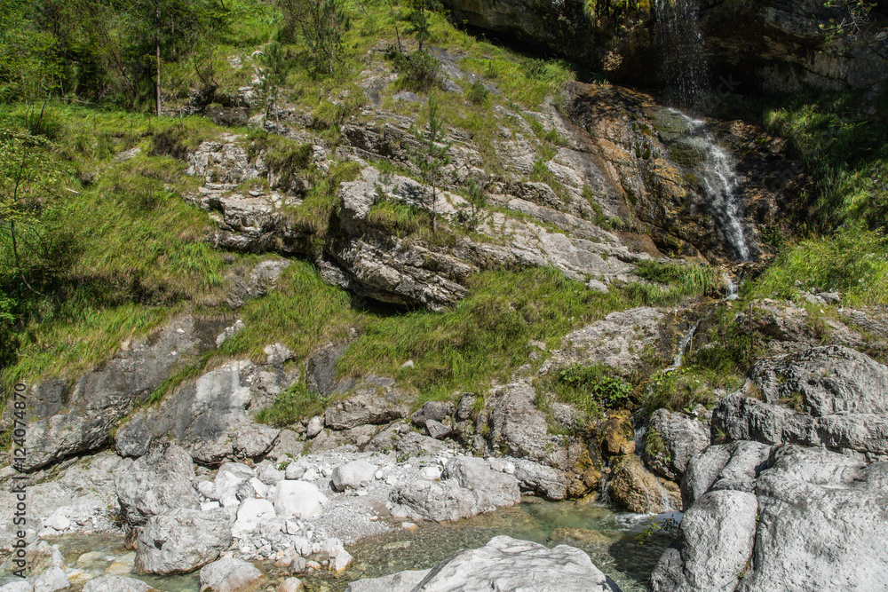 Malerische Gebirgslandschaft mit einem Wasserfall im Tal Valle di Piero; Dolomiten, Sommer