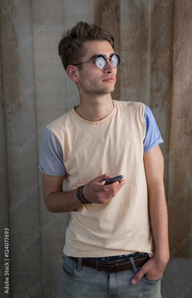 Fototapeta premium Teenage skater boy using smartphone wifi connected. Teenager por