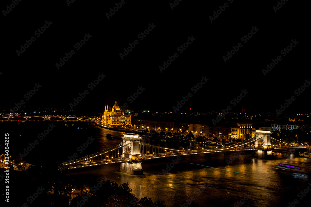Chain Bridge over the Danube with Hungrian Parliament in background  illuminated at night, Budapest, Hungary – 23 Sep 2016