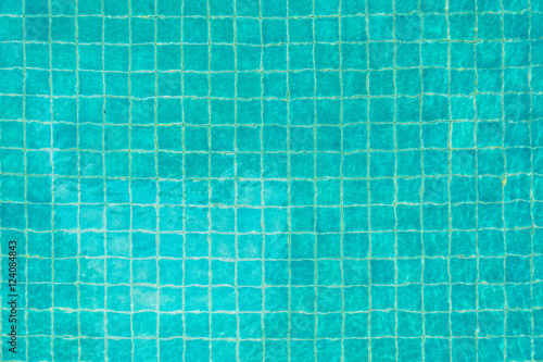 Blue-green swimming pool bottom with water wave texture