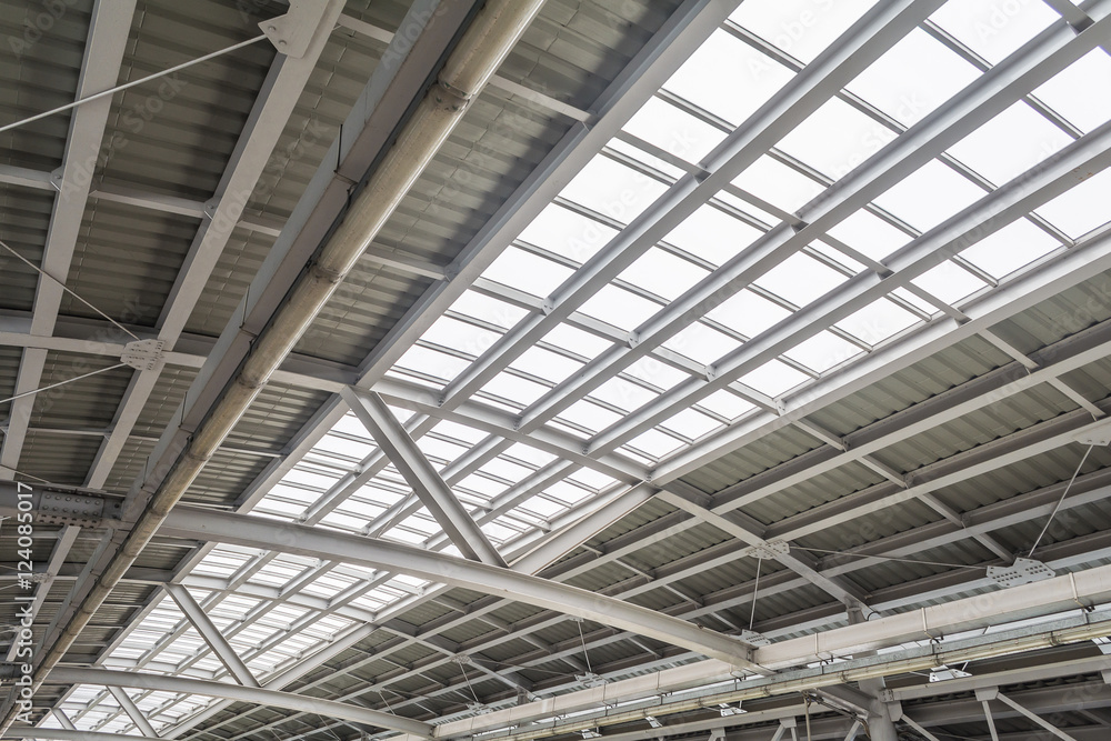 Gray and white metal roof structure in sunny day.