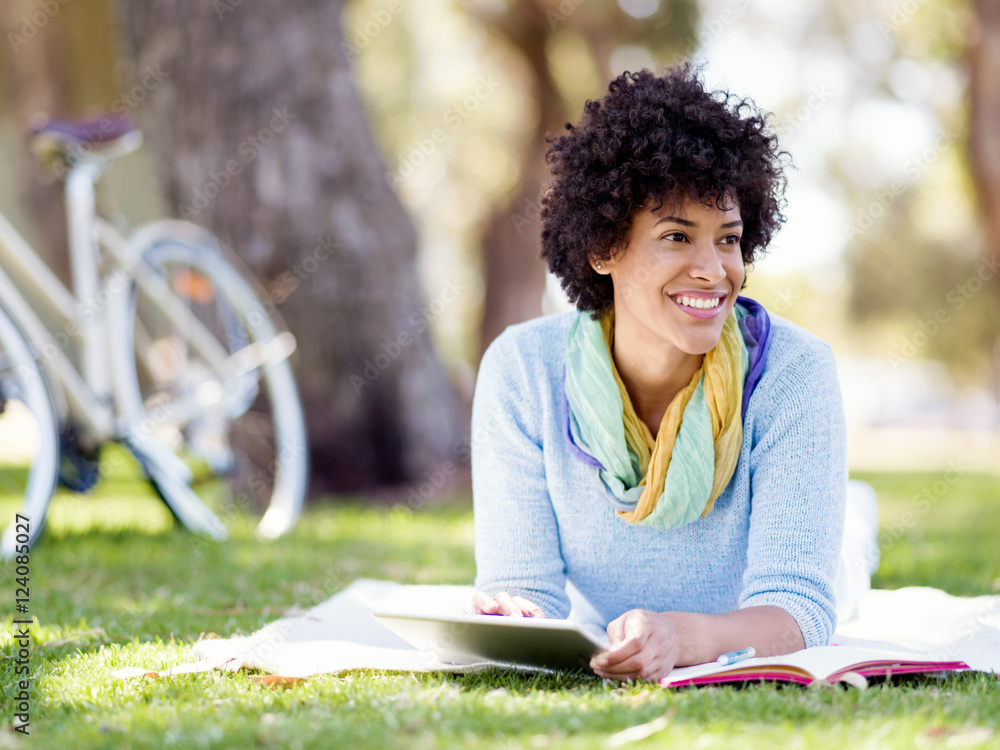 Young woman using tablet in the park. Young woman using tablet in the park.