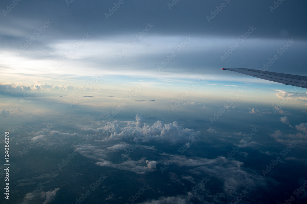 View of the clouds and airplane wing from the Inside