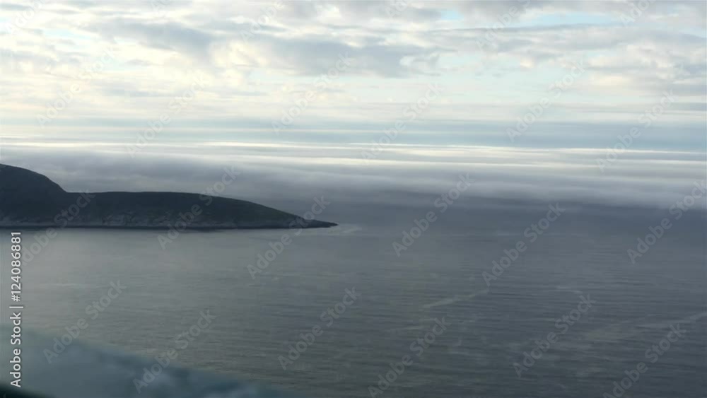 Waves of fog, moving in towards the mountain that holds the sphere of Nordkapp, in Finnmark, Norway Waves of fog, moving in towards the mountain that holds the sphere of Nordkapp, in Finnmark, Norway