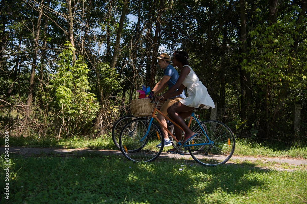 Young multiethnic couple having a bike ride in nature