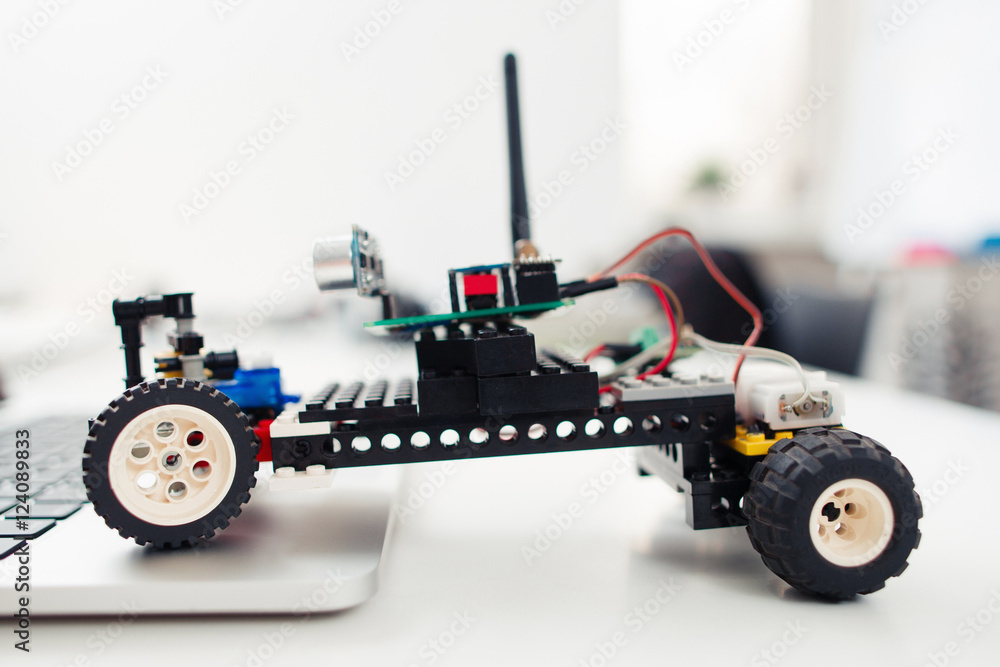 Handmade rc car from children construction, side view. Diy toy, electronics development, hobby concept Handmade rc car from children construction, side view. Diy toy, electronics development, hobby concept