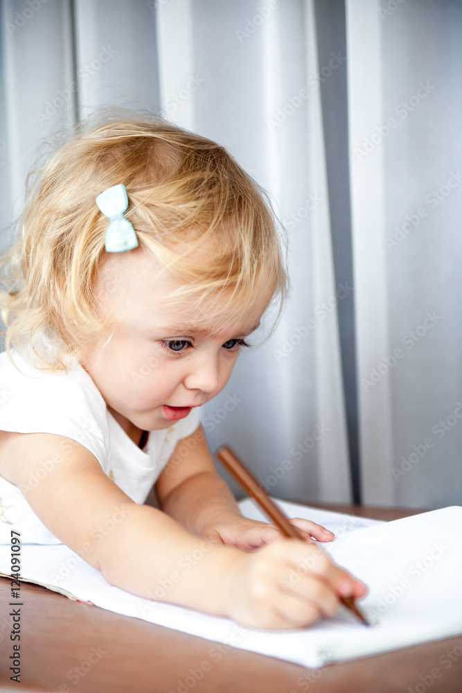 Little girl drawing at home