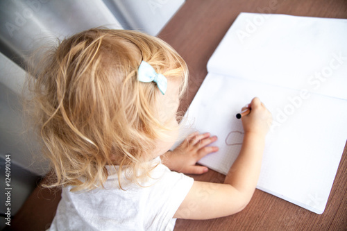 Little girl drawing at home