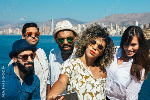 Stylish group of friends in sunglasses makes selfie