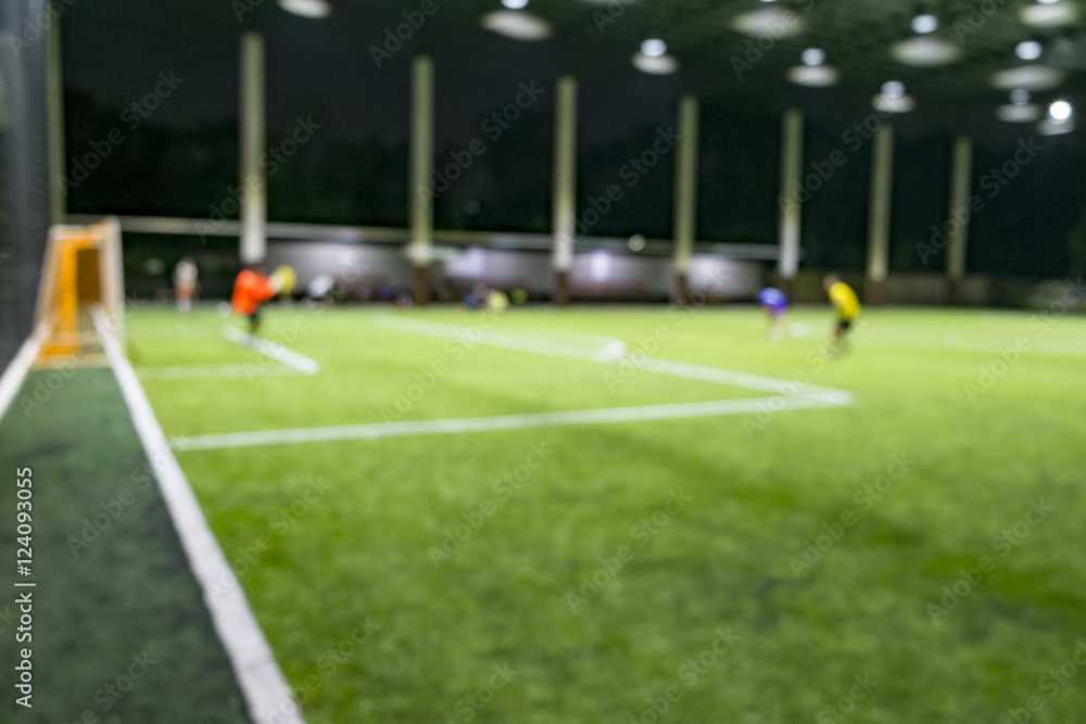 defocused of people playing soccer in the Artificial Turf soccer field