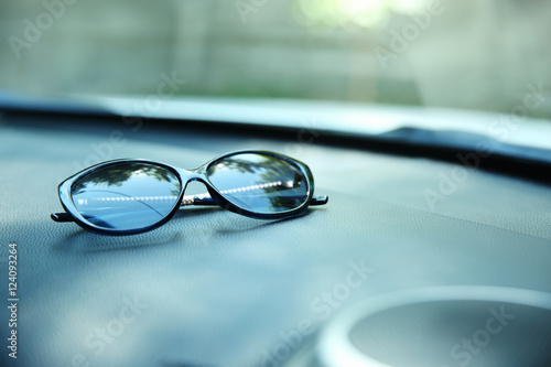 Sunglasses on car panel, closeup