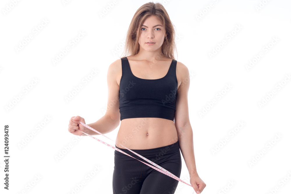 serious athletic girl who looks forward and holding a measuring serious athletic girl who looks forward and holding a measuring
