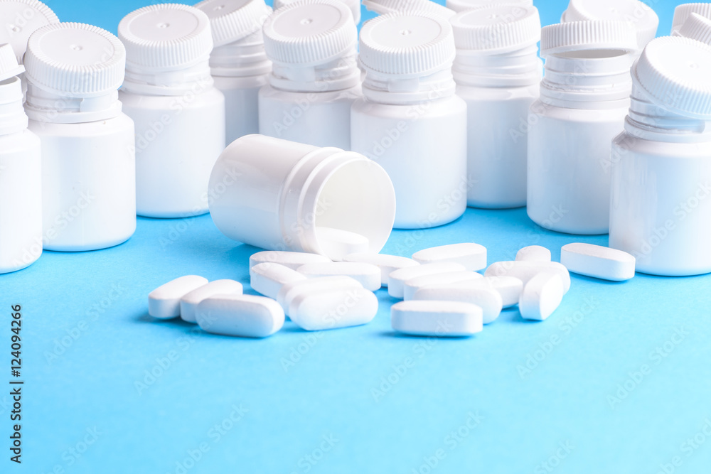 Many pills and tablets isolated on light blue background Many pills and tablets isolated on light blue background