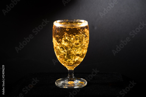 water with glass at black background