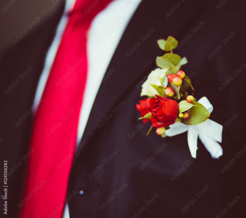 Boutonniere made of tiny red roses and green leaves Boutonniere made of tiny red roses and green leaves