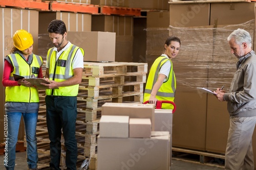 Warehouse manager and workers preparing a shipment 