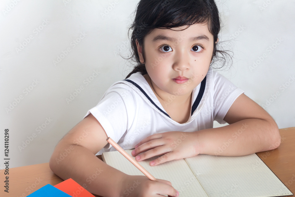 Beautiful little girl looking focused and concentrated on doing Beautiful little girl looking focused and concentrated on doing