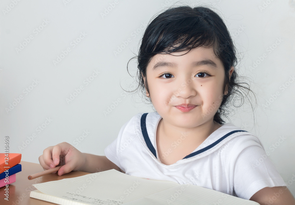 Beautiful little girl looking focused and concentrated on doing Beautiful little girl looking focused and concentrated on doing