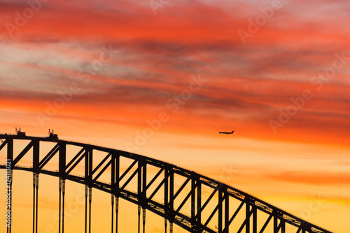 Colorful dramatic sky with silhouette of Sydney Harbour Bridge © Olga K