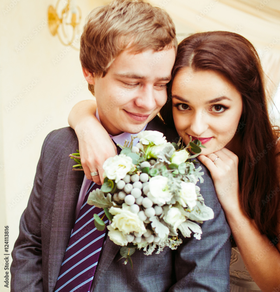 Charming brunette lady leans on her man's shoulder while holding Charming brunette lady leans on her man's shoulder while holding