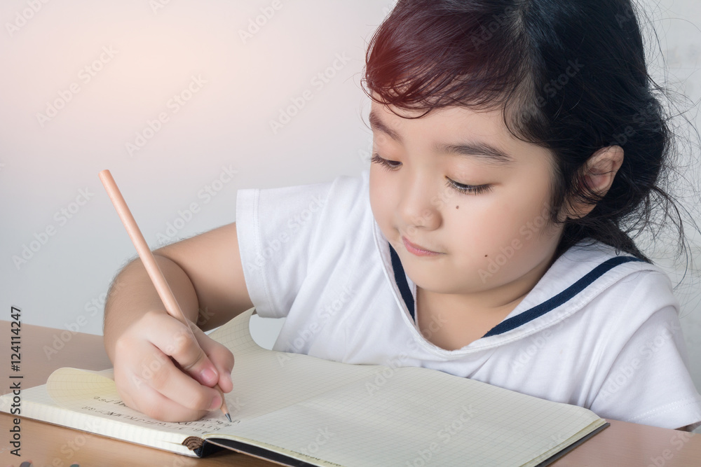 Beautiful little girl looking focused and concentrated on doing Beautiful little girl looking focused and concentrated on doing