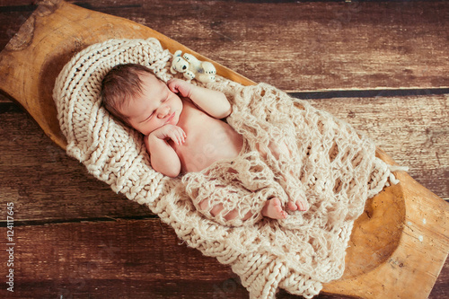Incredible and sweet newborn baby sleeps on the bed