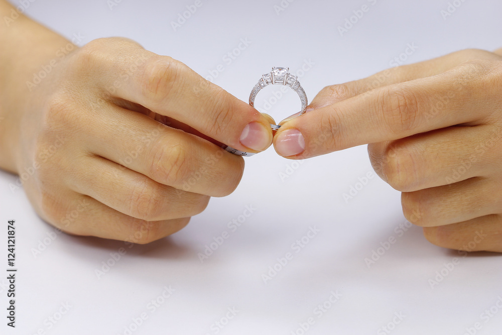 Hands holding a ring on a white background Hands holding a ring on a white background