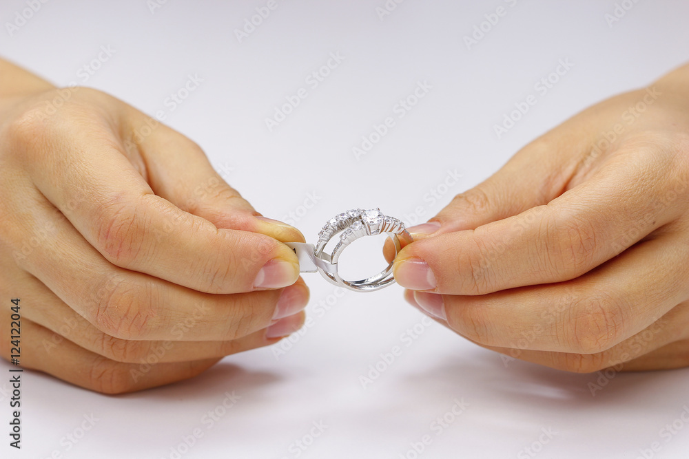 Hands holding a ring on a white background Hands holding a ring on a white background