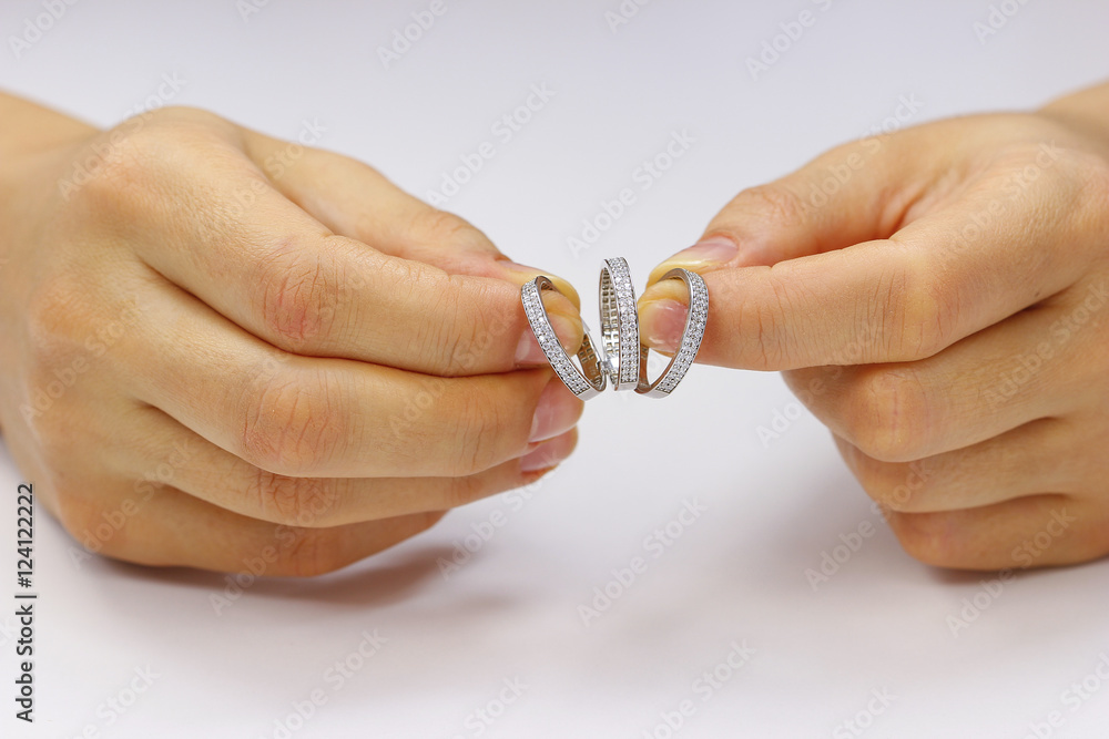 Hands holding a ring on a white background Hands holding a ring on a white background