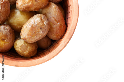 Young baked tasty potatoes in clay pot on white background