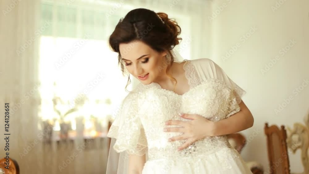 The bride looking at her wedding dress The bride looking at her wedding dress