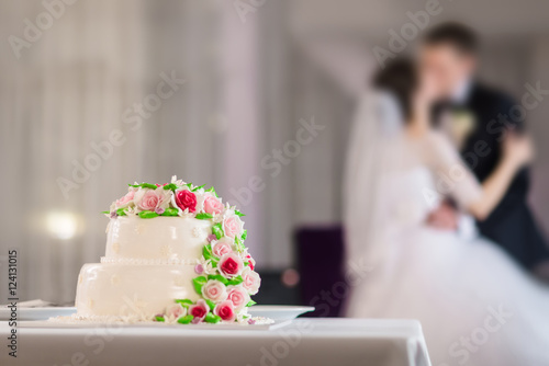Wedding cake and bride, groom in the restaurant