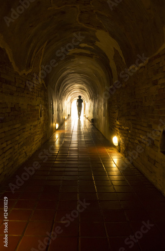A man in the old brick tunnel  silhouette