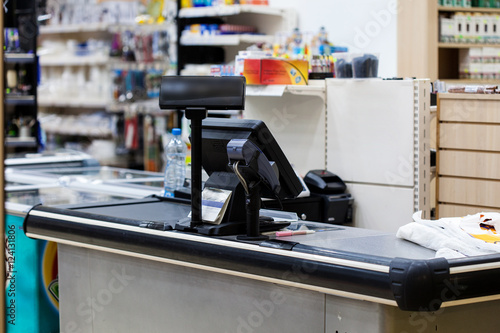 Empty cash desk with terminal in supermarket