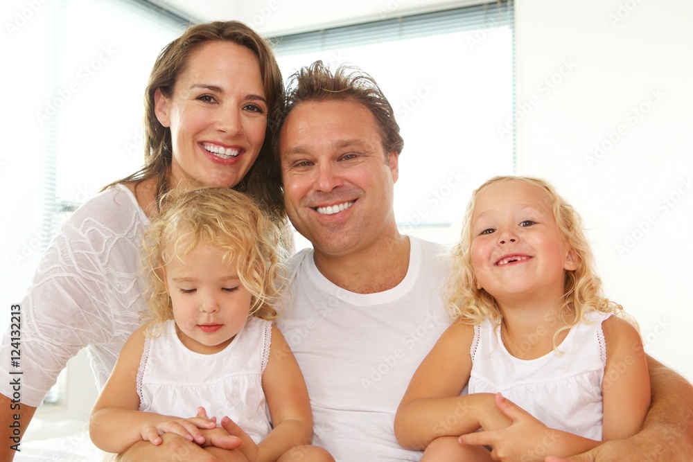 Happy young parents with daughters at home Happy young parents with daughters at home
