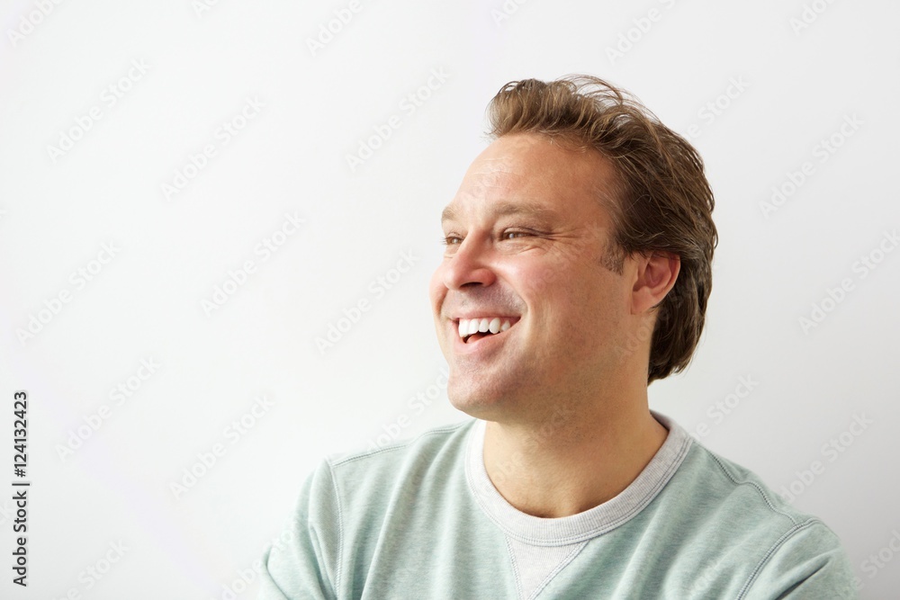 Handsome young man looking away and smiling Handsome young man looking away and smiling
