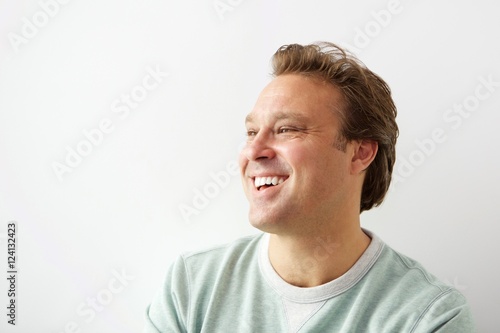 Handsome young man looking away and smiling