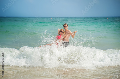 happy couple in the sea and the waves
