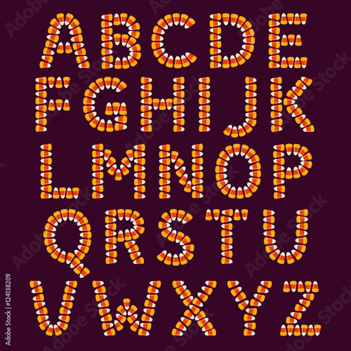 Halloween pattern with small candy corns sweets on dark background. Holiday trick or treat concept.