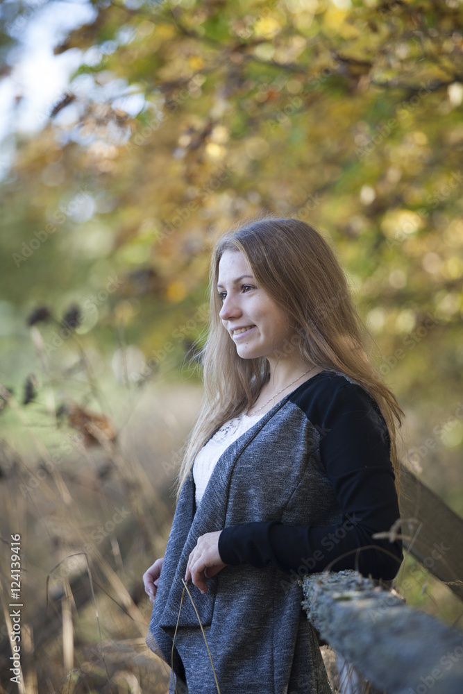 Girl with a cute smile on sunny autumn day Girl with a cute smile on sunny autumn day