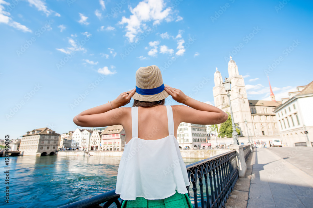 Female tourist enjoying cityscape view on the old town of Zurich city. Woman having happy vacations in Switzerland