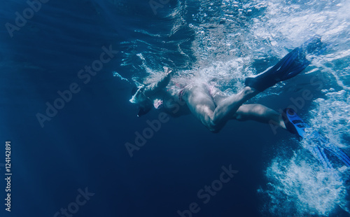 Woman freediver swimming in the sea photo