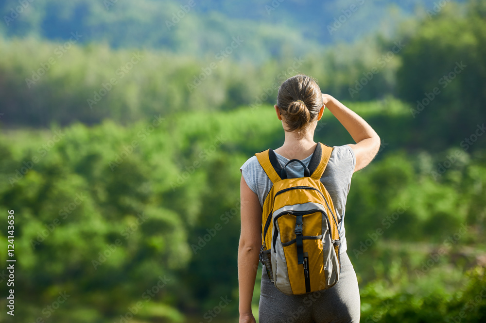 Fototapeta premium Young traveling woman with backpack. focus on traveller