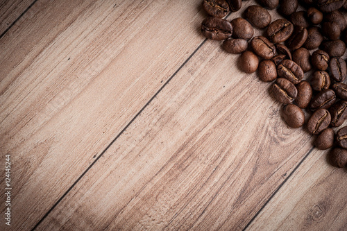 roasted coffee beans on wooden background, can be used as a background