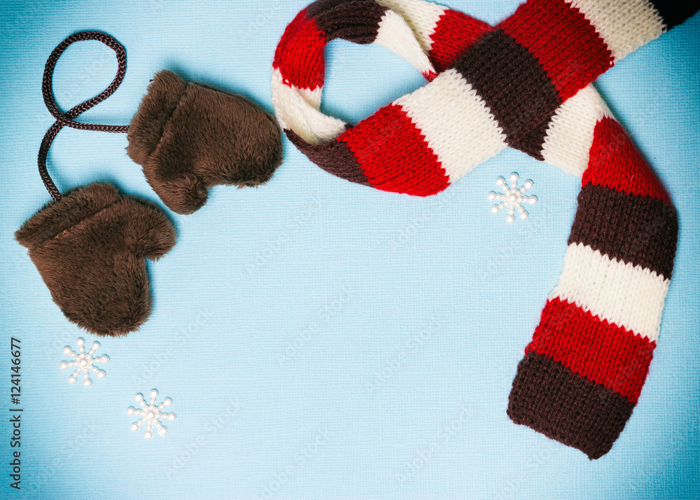 Winter frame with mittens, scarf and small snowflakes