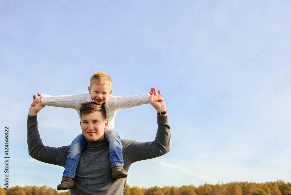 Father and son playing outdoors together. Father and son playing outdoors together.