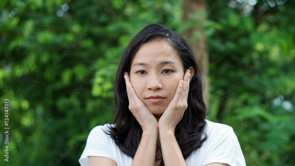 South East Asian girl looking away green background South East Asian girl looking away green background