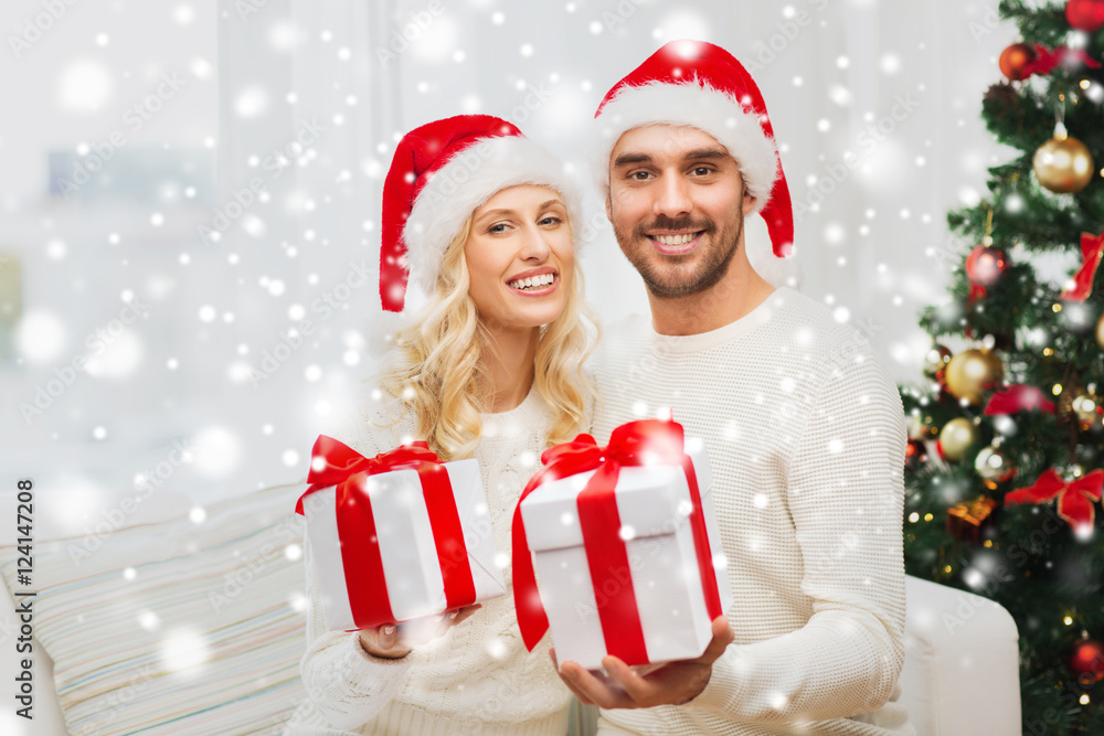 happy couple at home with christmas gift boxes happy couple at home with christmas gift boxes
