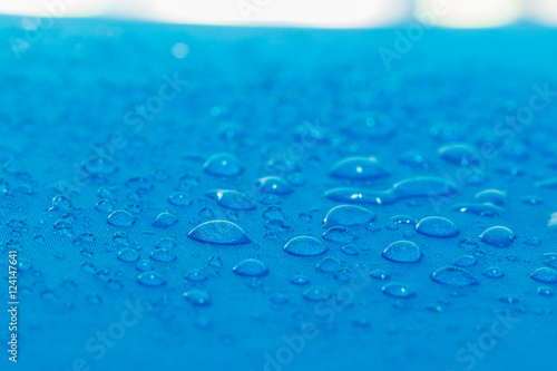 Water droplets on blue fiber waterproof fabric