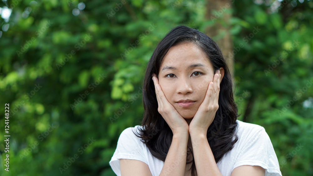 South East Asian girl looking at camera green background South East Asian girl looking at camera green background